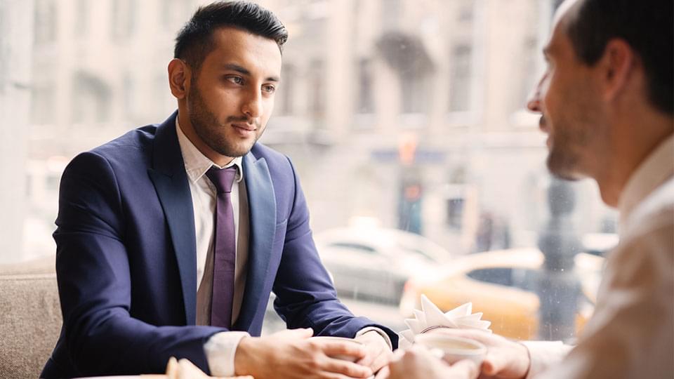 two men having coffee