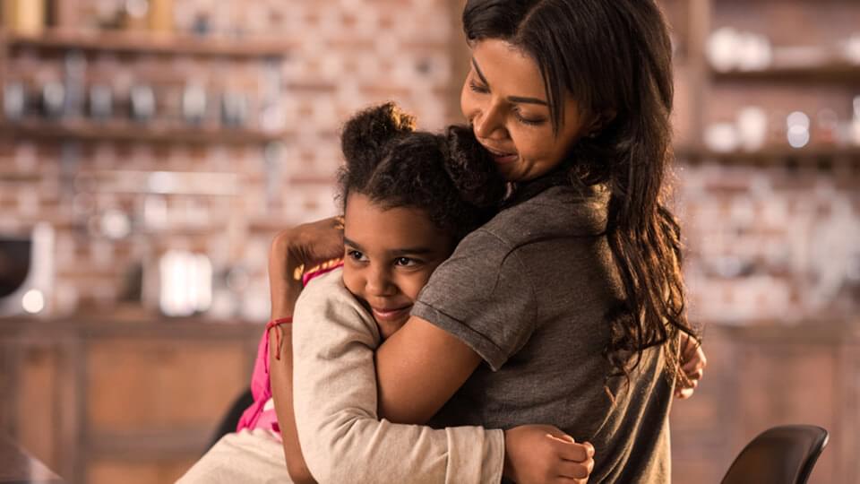 Mother and daughter hugging